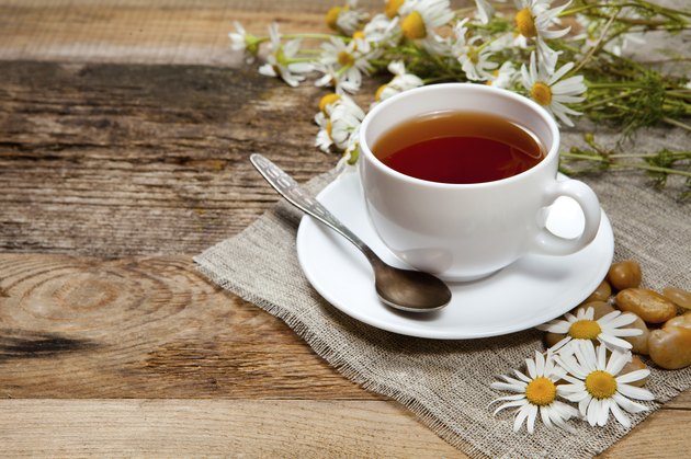 herbal tea with chamomile on old wooden table