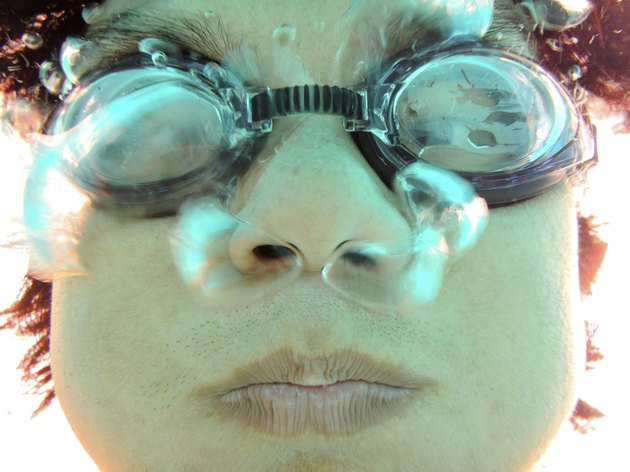 closeup man face with swimming goggles