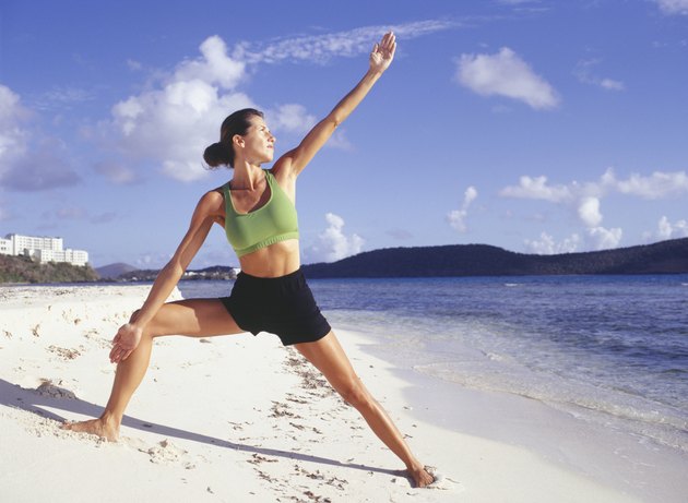 Woman doing yoga on beach