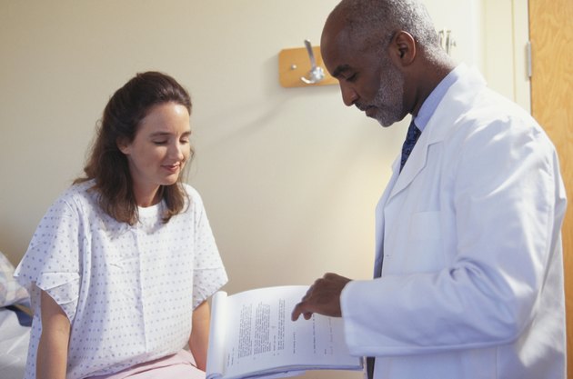 Doctor talking with patient in hospital room