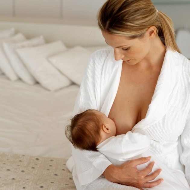 Close up view of a mother breastfeeding her baby (6-12 months)