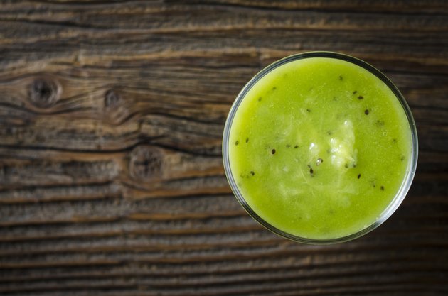 Kiwi juice over wooden table