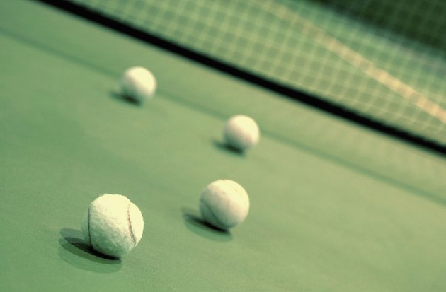 Four tennis balls on a tennis court