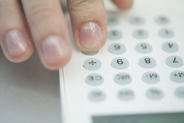 Woman using calculator, extreme close-up
