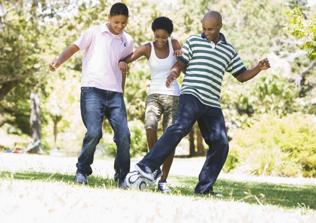 Family kicking ball