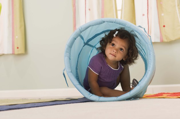 Toddler inside a toy tunnel