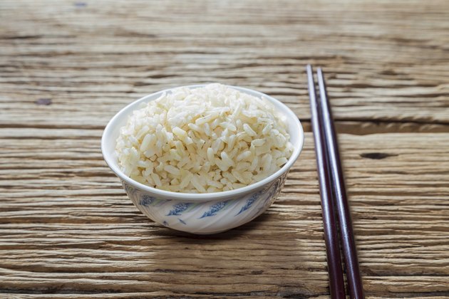 Bowl of brown rice with chopsticks