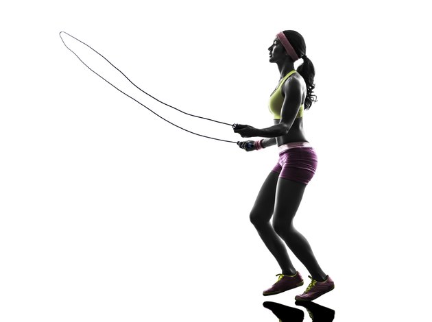 woman exercising fitness jumping rope silhouette