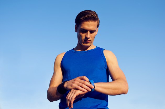 Handsome athlete checking pulse