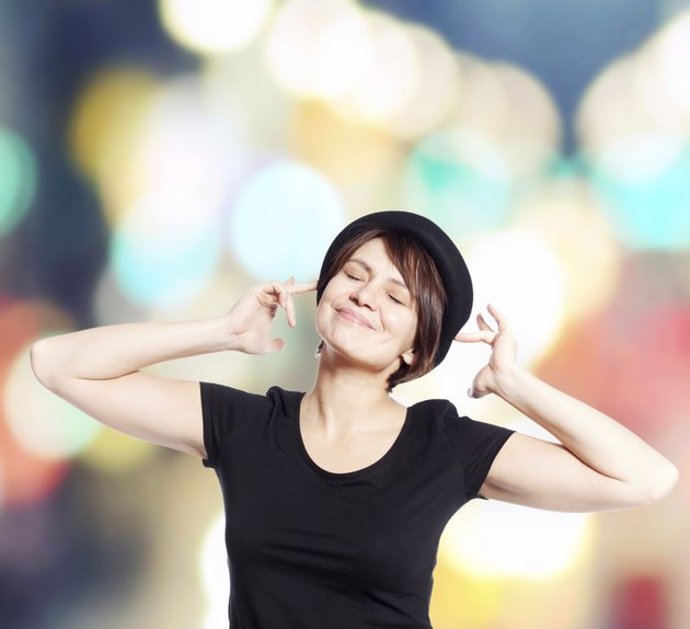 young woman in black hat smiling
