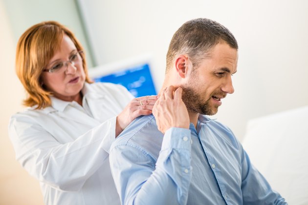 Female Doctor Examining Patient's Back