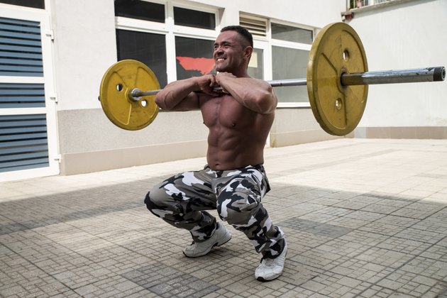 Bodybuilder Doing Front Squats With Barbells