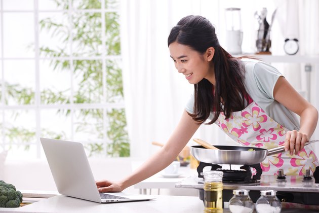 Young woman cooking in kitchen