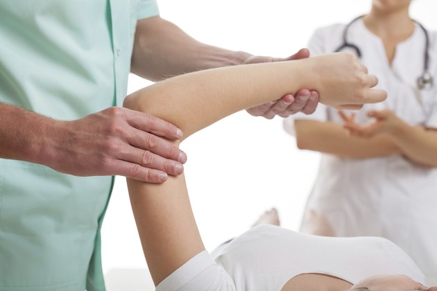 Doctors examining injured arm