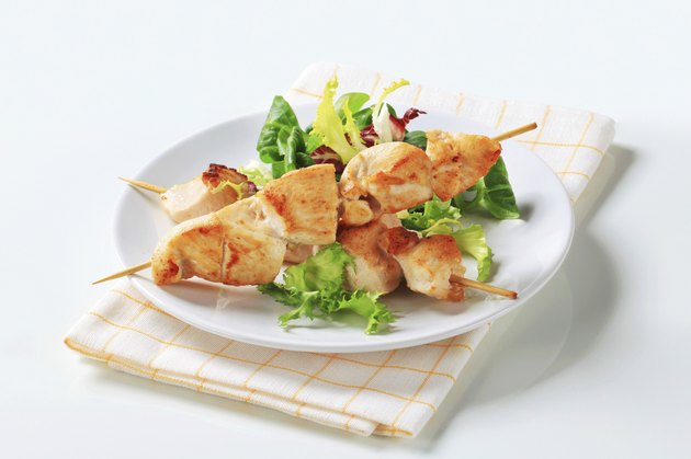 Chicken skewers and salad greens