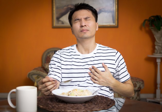 Asian man has a Heart attack symptoms while eating
