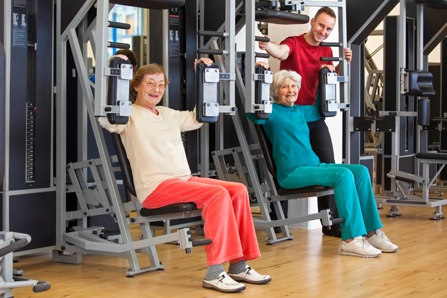 Smiling Elderly Women at the Gym with Instructor.
