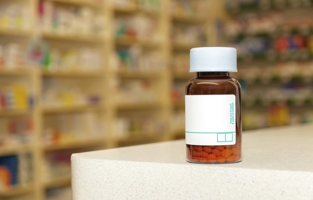 Medicine bottle with pills and a blank label
