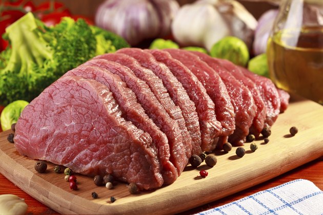 Raw beef and vegetables on wood