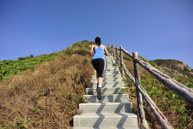 woman running up on mountain stairs