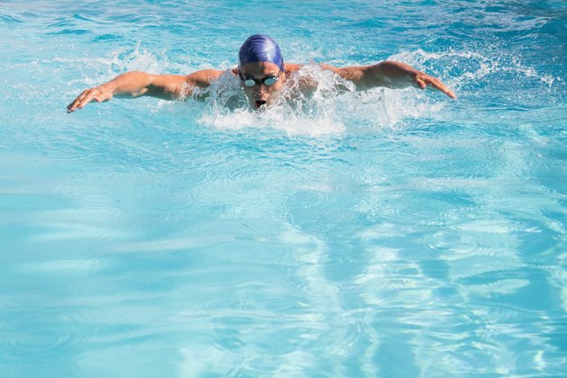 Fit swimmer doing the butterfly stroke in the swimming pool