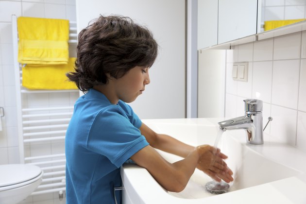 Little boy washing his hands
