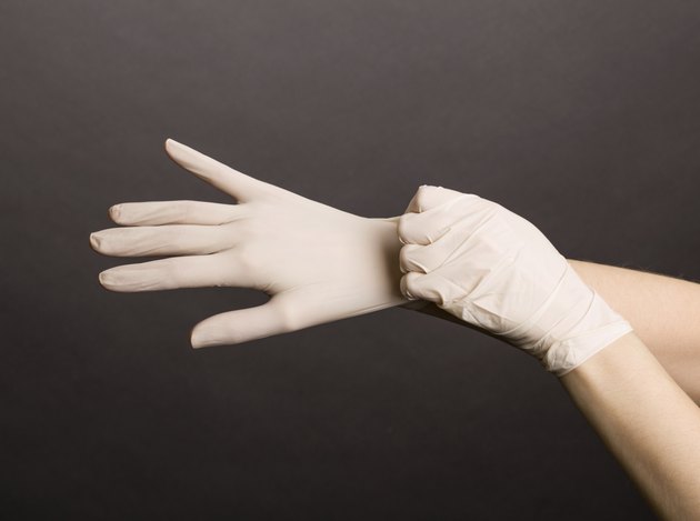 Female hands in latex gloves