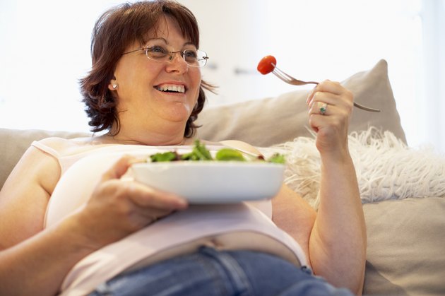 Overweight Woman Relaxing On Sofa