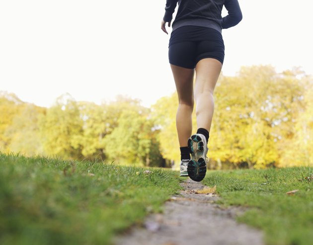 Rear view of woman athlete jogging in park