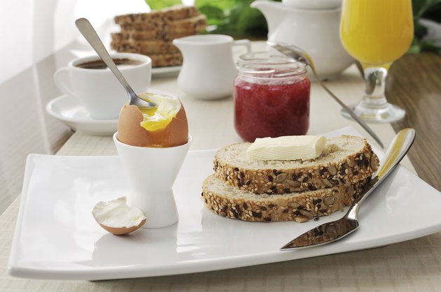 Breakfast soft-boiled egg and slices of oatmeal bread