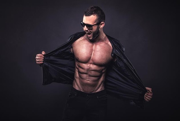 Crazy fit man posing in studio.