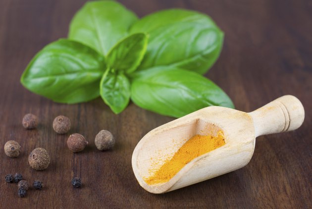 turmeric in wooden spoon