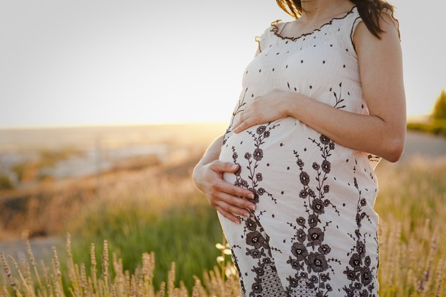 Pregnant girl dressed on the field