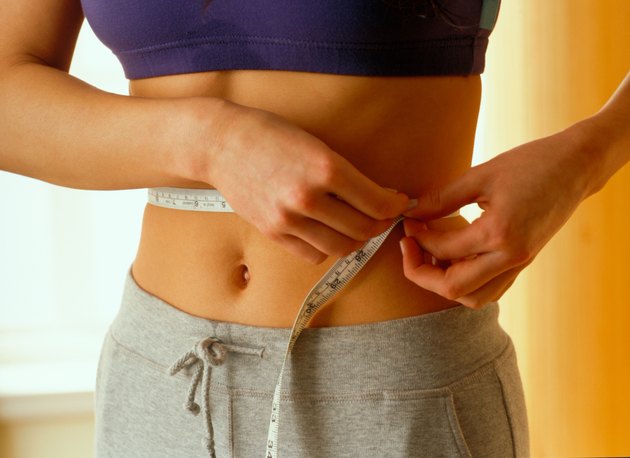 Woman measuring herself