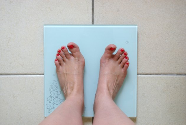 Woman weighing herself