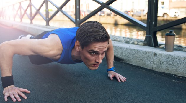 Picture of young handsome athletic man doing pushups