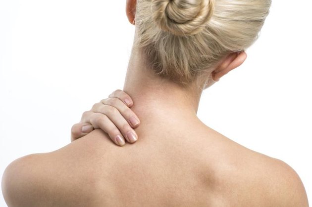 Blond women with neck and backache rubbing area to ease pain
