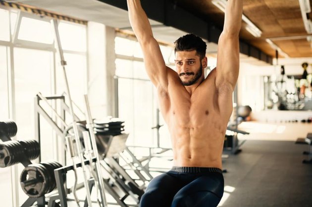 Abs workout by handsome man in gym