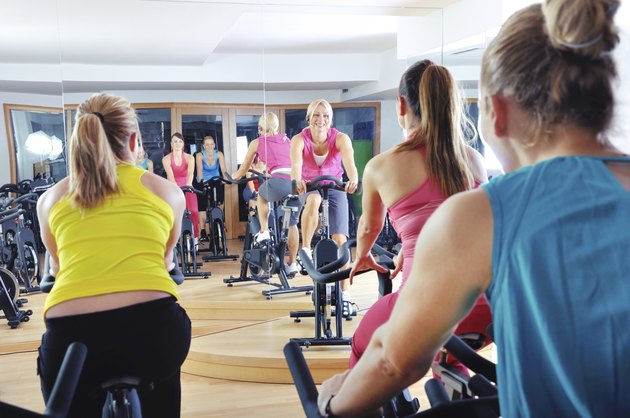 Beautiful women doing exercise in a spinning class at gym