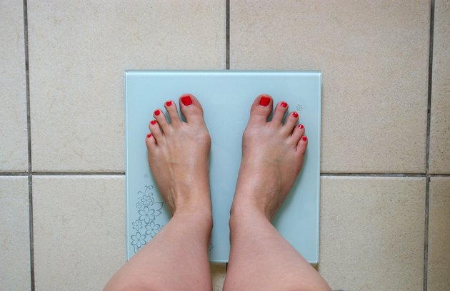 Woman weighing herself