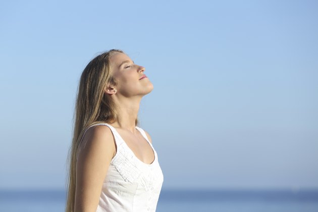 Beautiful blonde woman breathing happy