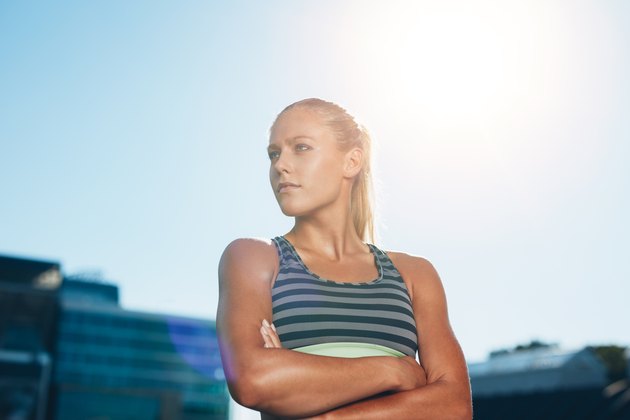 Muscular female athlete in outdoors stadium