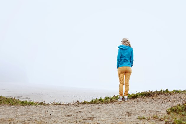Girl on foggy beach