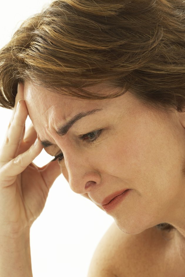 Mature woman crying, side view, close-up