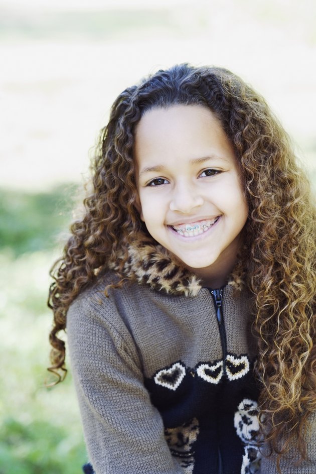 Young African girl with braces smiling