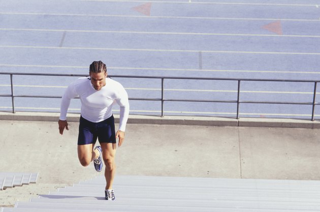 Man running up steps at sports stadium, elevated view