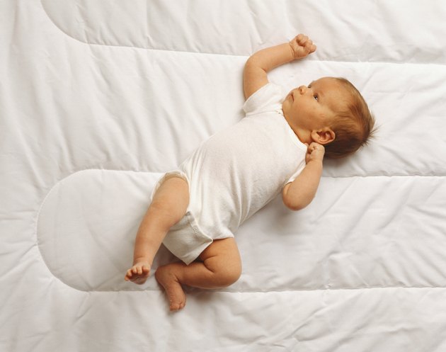 Baby (3-6 months) lying on bed