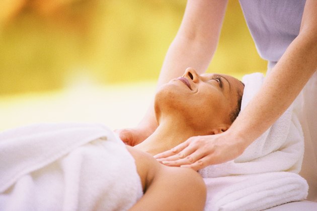 Woman getting massage, lying on back