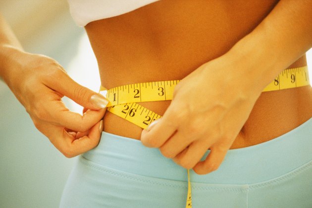 Woman measuring waistline