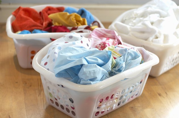 Clean washing in three plastic laundry baskets